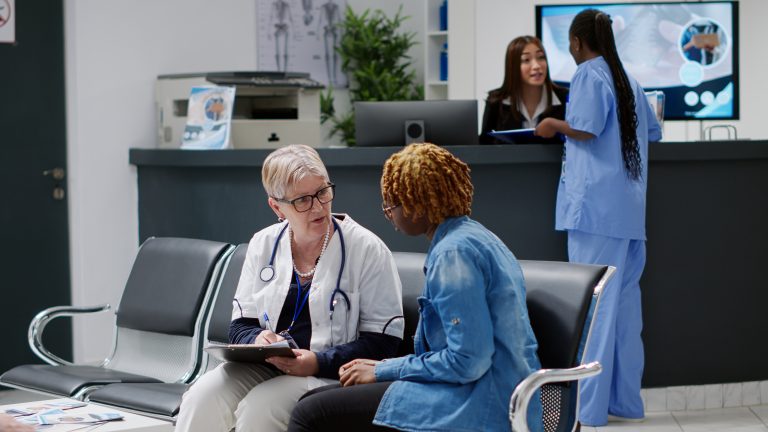 doctor and patient having a conversation in a hospital waiting room